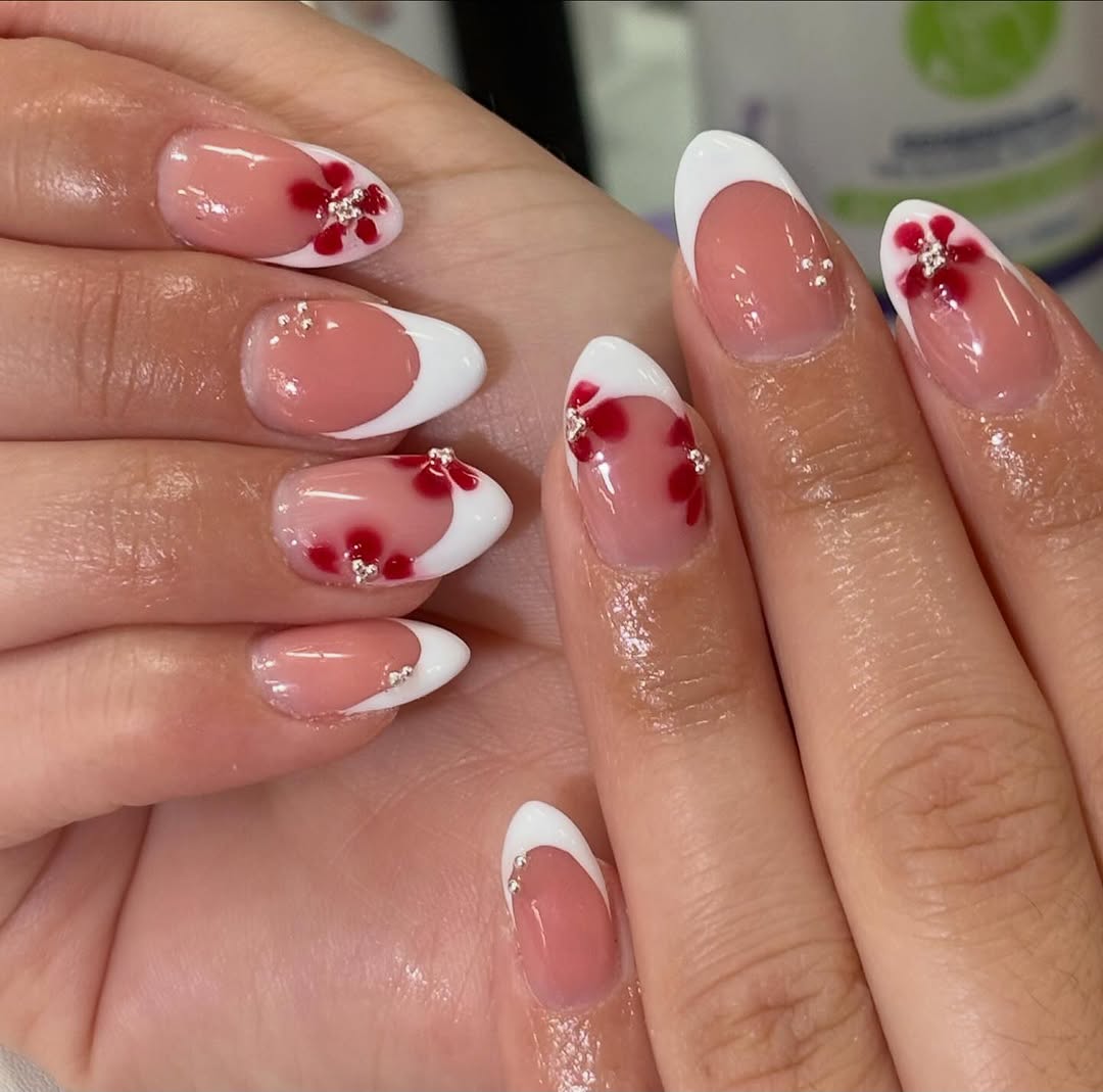 French tip nails with red flower accents