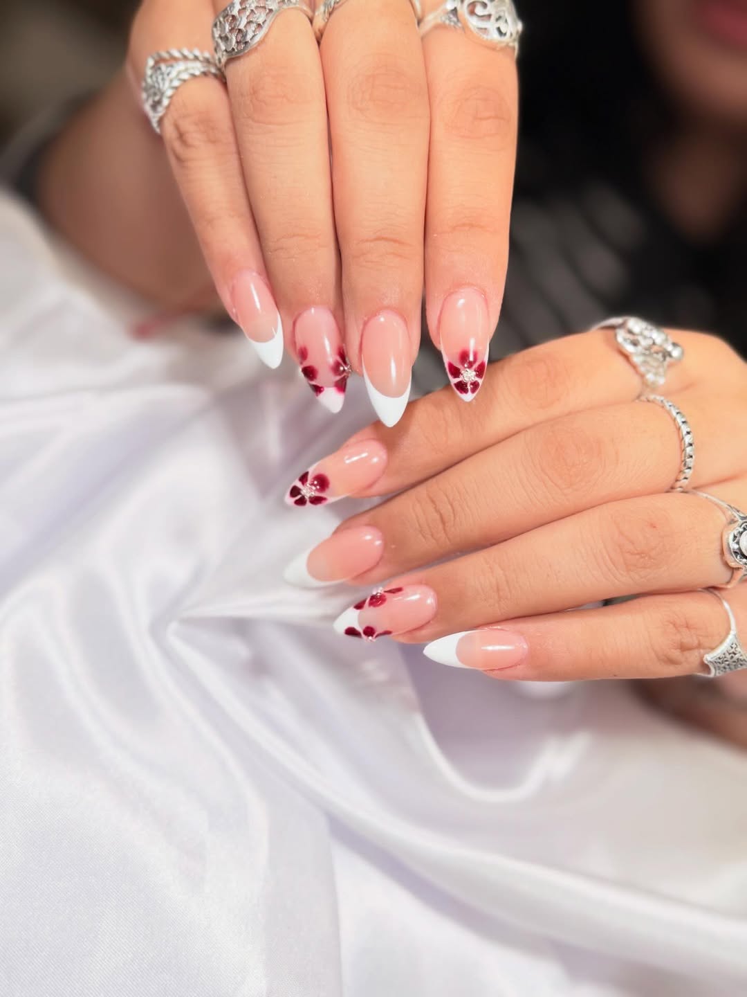 French tip nails with floral art by La Fleur Nail Salon