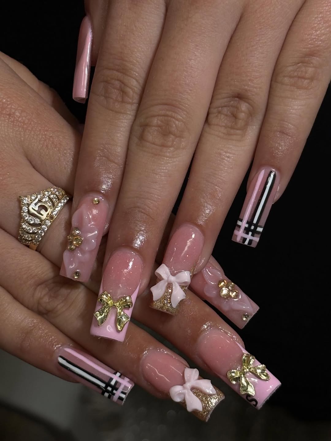 Designer-inspired pink nail art with gold accents